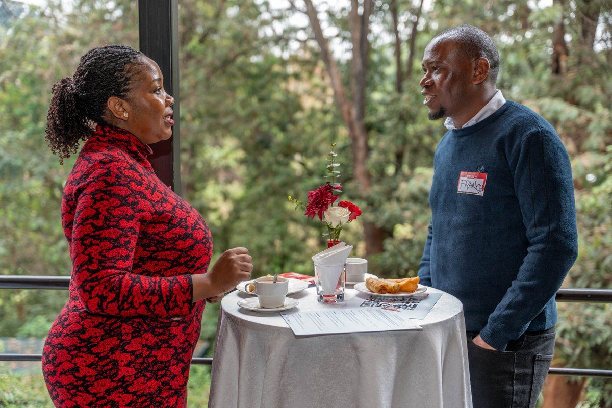 Two delegates in conversation over coffee at the summit